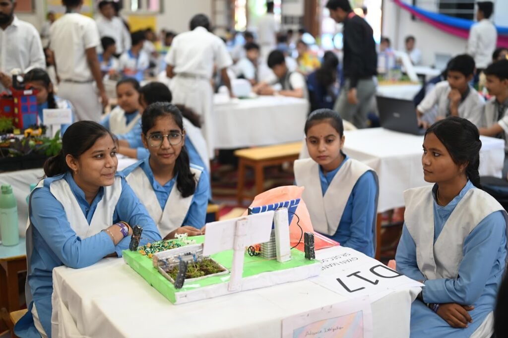 Students in a Chennai school STEM lab present their science project model.