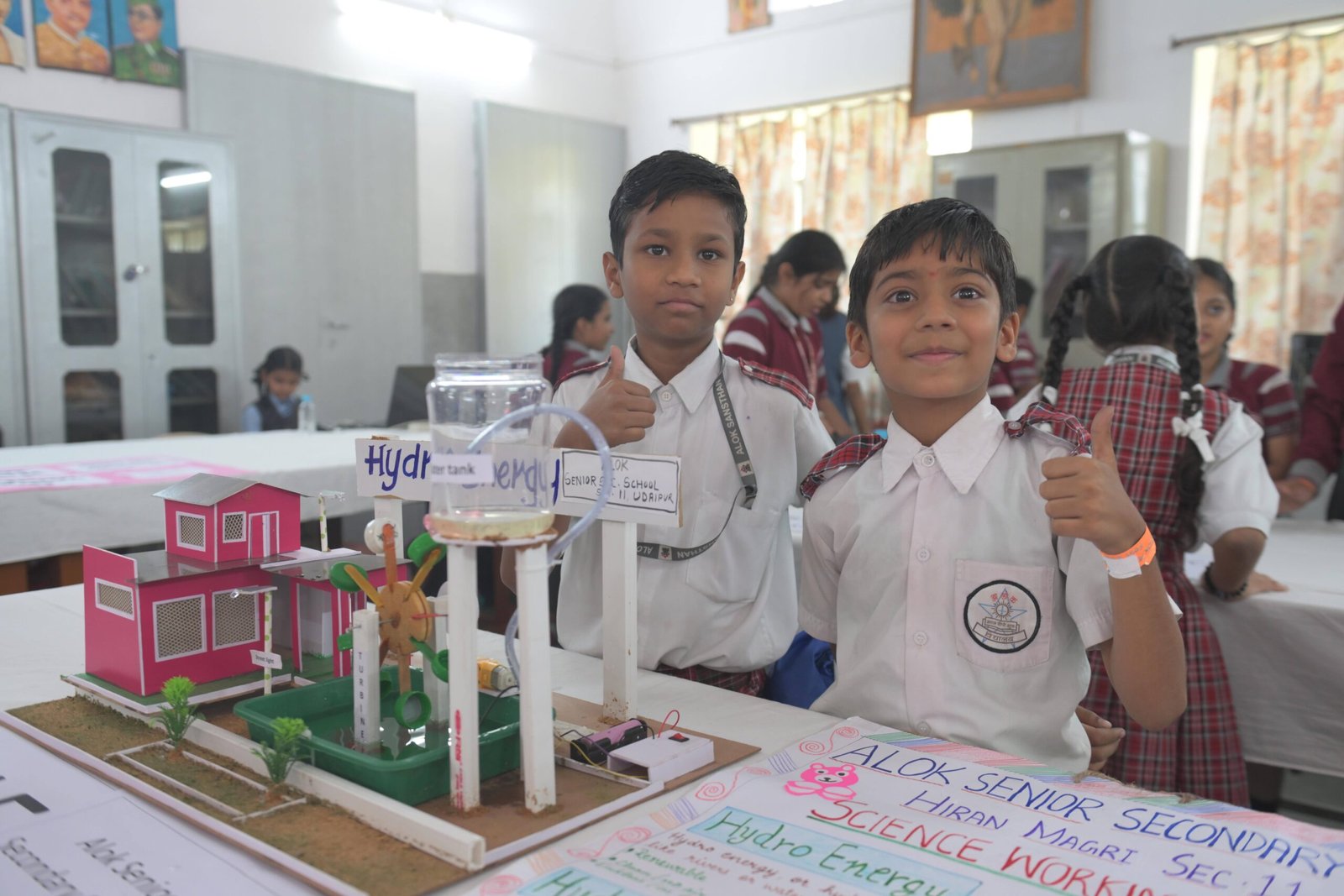 Children demonstrating a hydro energy model at a school science exhibition