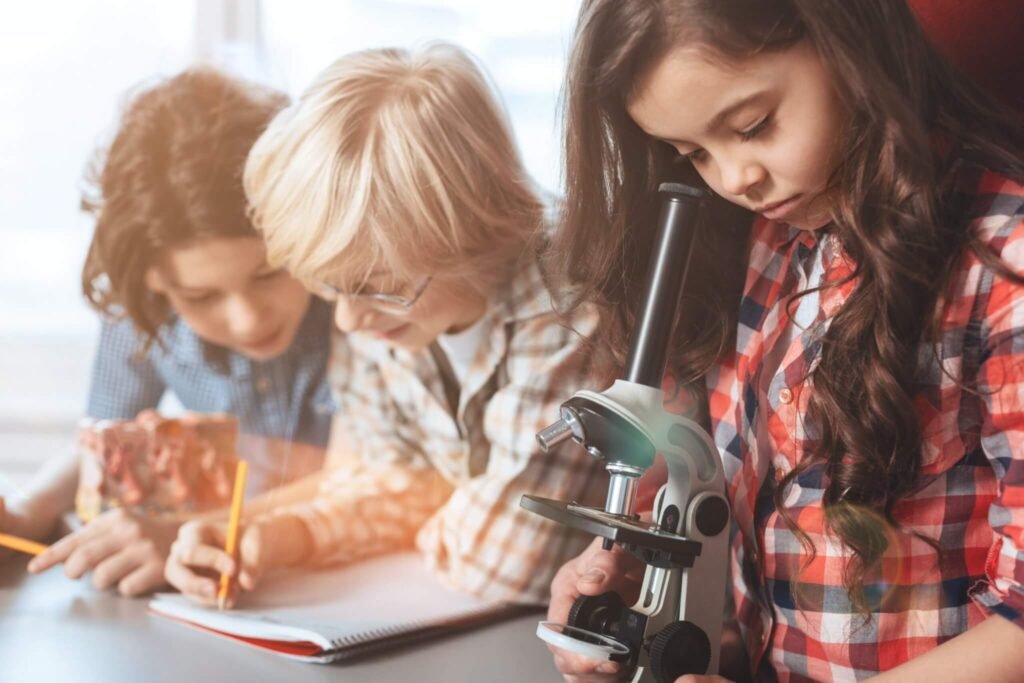 Girl examining a slide under a microscope in a stem lab in Chhattisgarh schools