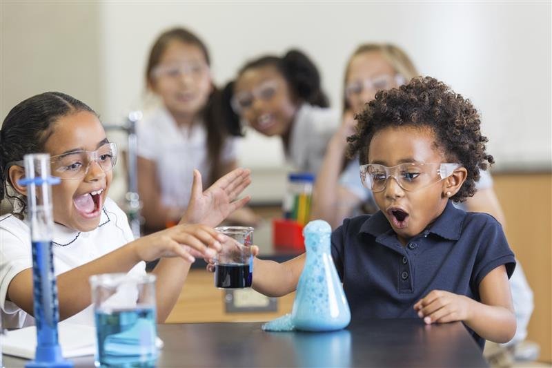 Young students react with excitement during a chemical reaction in a stem lab in Chhattisgarh schools.