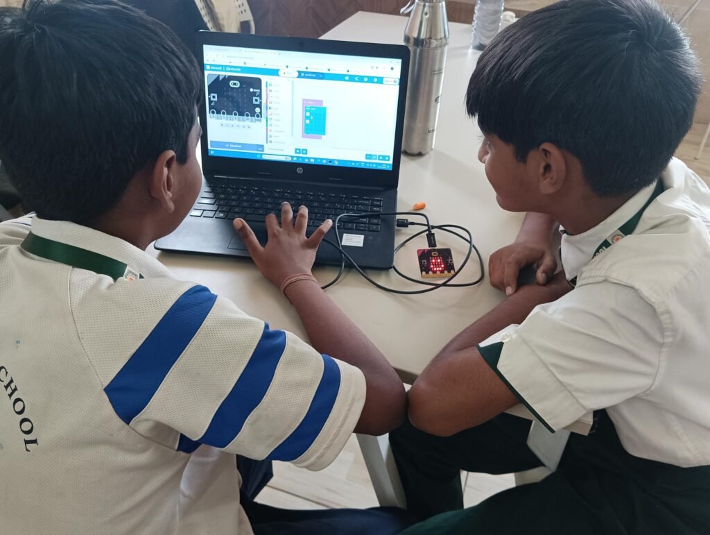 Two boys programming a microcontroller in a hands-on STEM Lab in Delhi Schools.