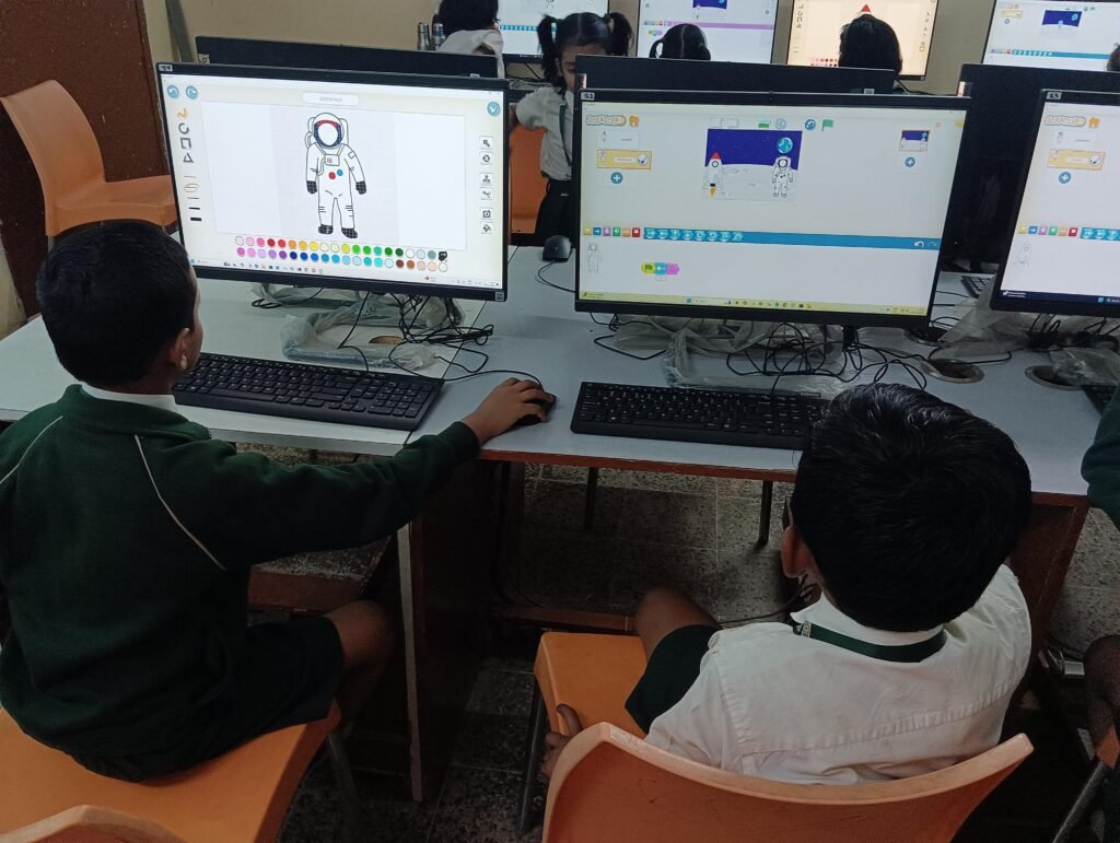 Children using educational software in a STEM lab in Chhattisgarh schools.