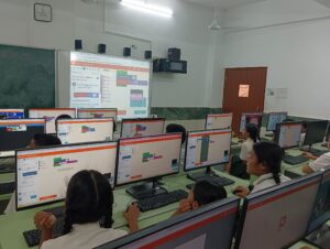 Students in a computer lab working on block-based coding projects