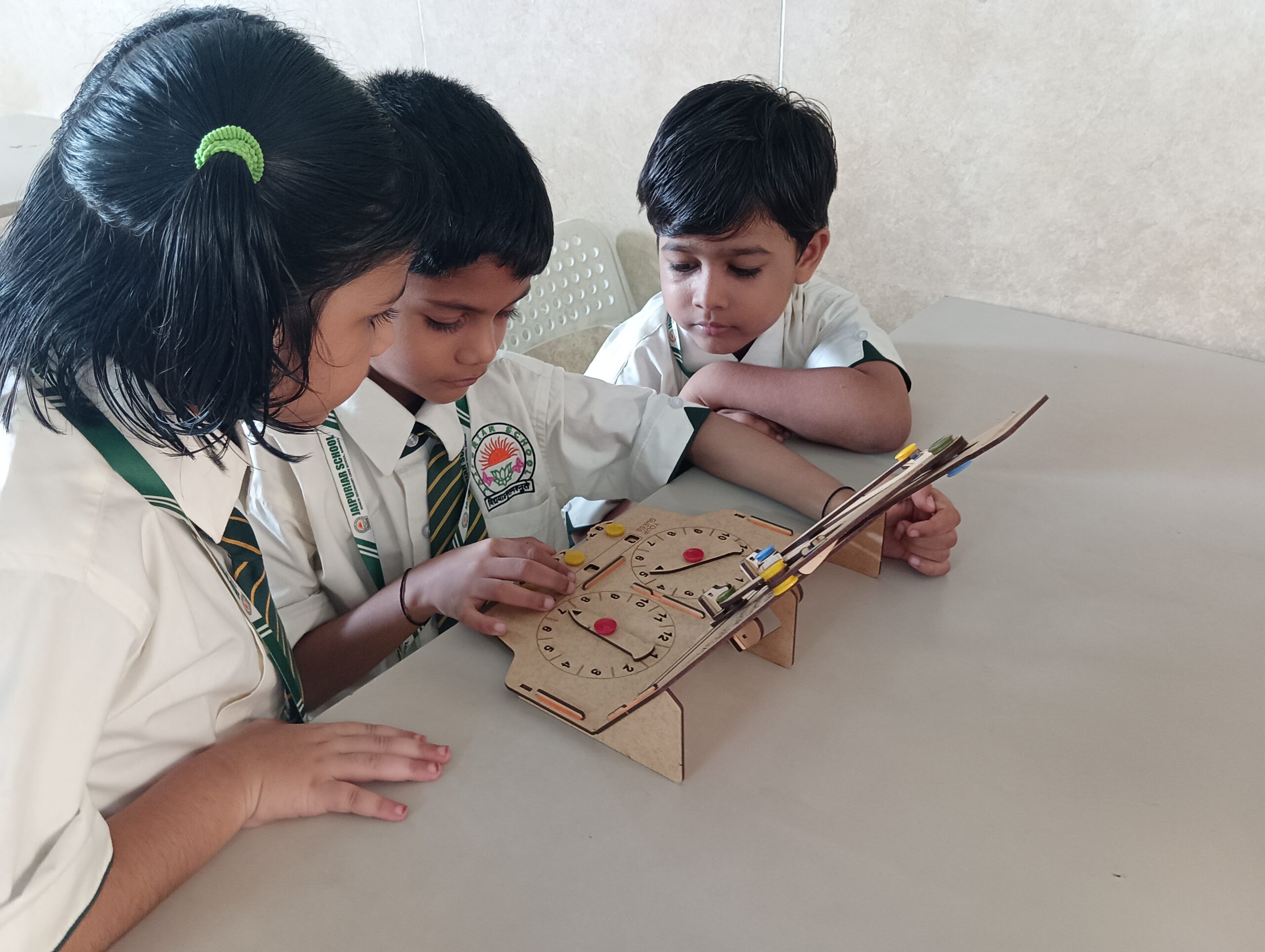 AI discovery course for Kids: A Complete Guide to Getting Started 18 Young students collaborating on a wooden mechanical STEM model