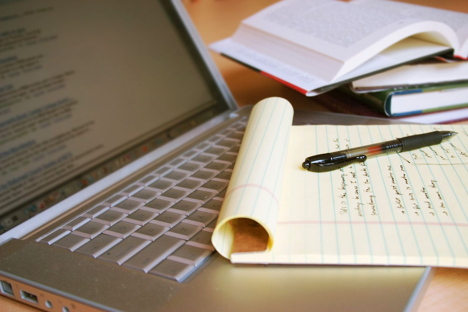 laptop computer with books pen and yellow legal pad 92259124 5c673ef9c9e77c00014762dc