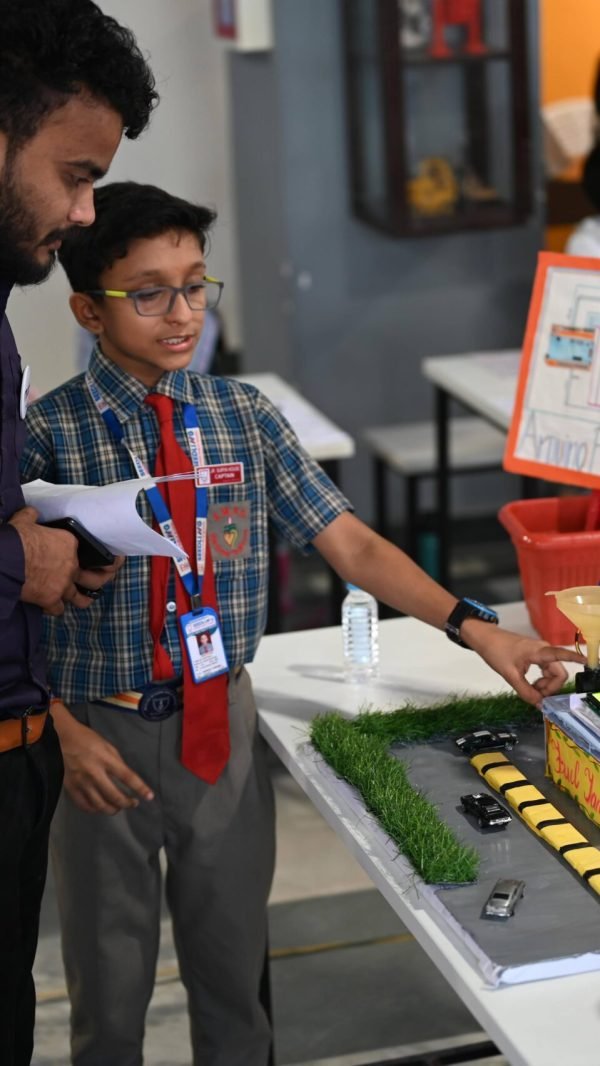 Student explaining a STEM project at a school exhibition in West Bengal