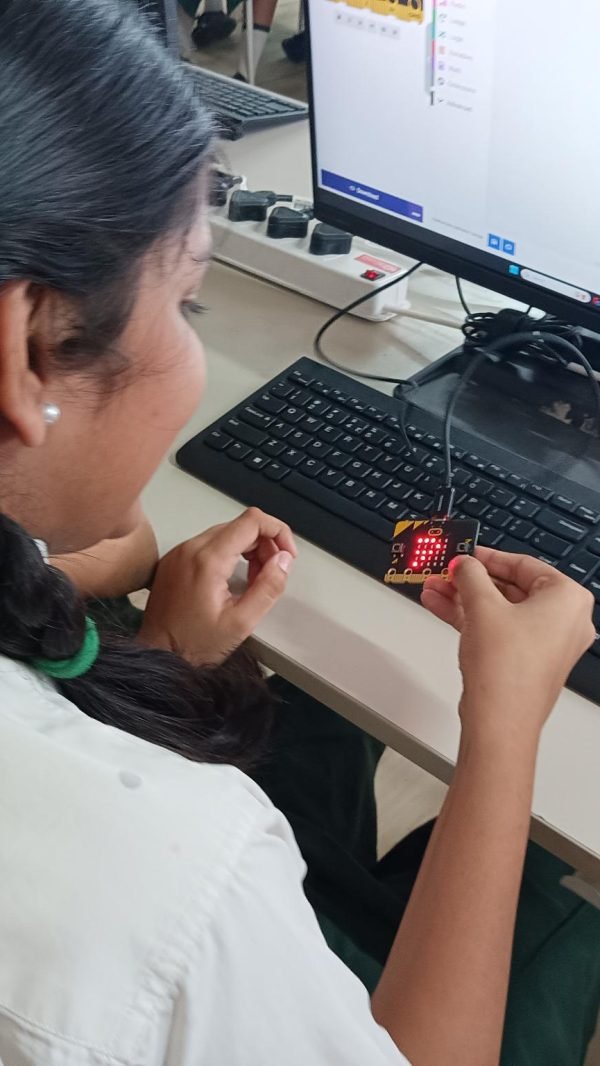 Girl using a microcontroller device in a STEM Lab in Delhi Schools.